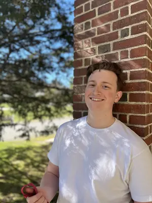 Alex Walley, tenor, in front of a brick wall in Saratoga Springs, NY. Captial District